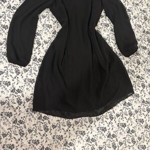 Black mini dress with elegant long sleeves and V-neckl